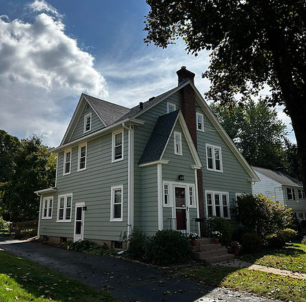 Aluminum siding house with fresh repaint in progress